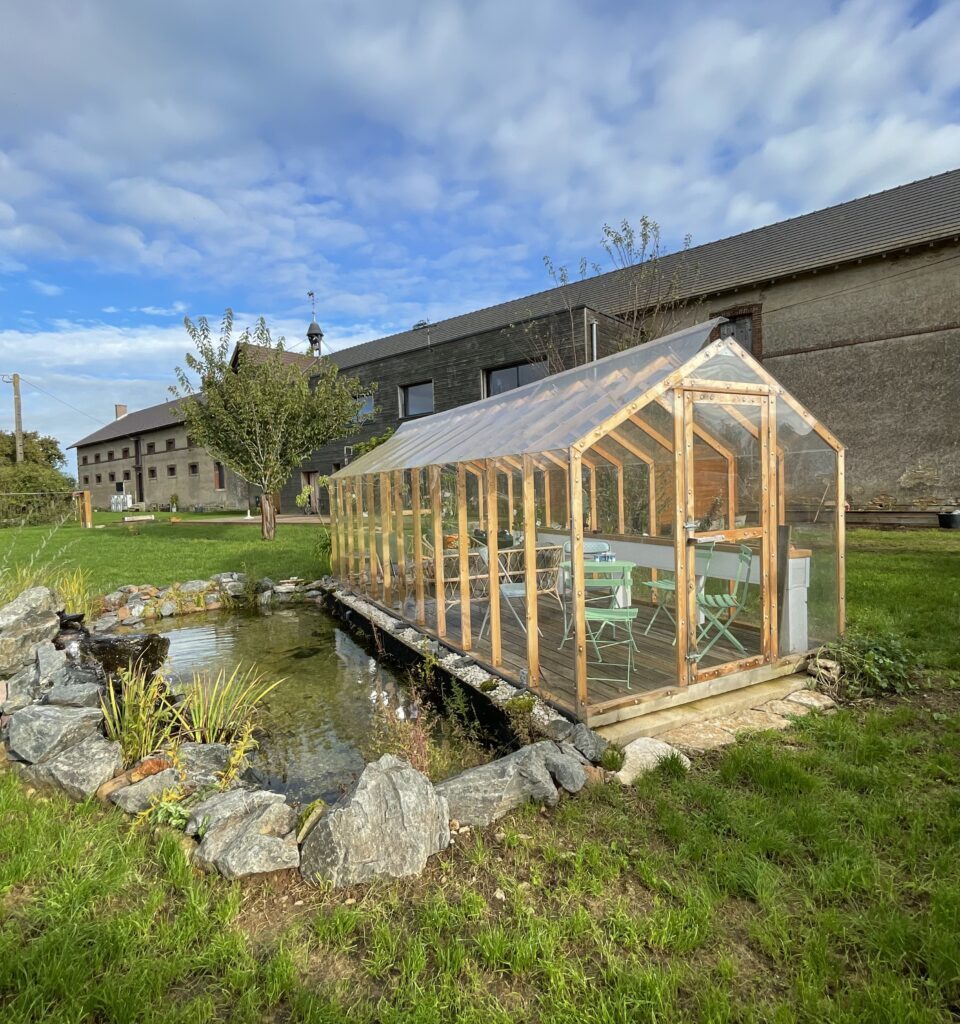 serre jardin paysagiste à côté d'un bassin d'eau